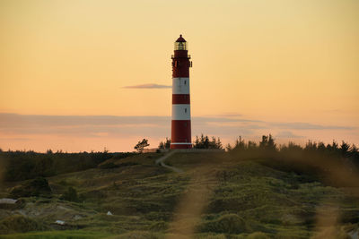 Lighthouse against sky during sunset