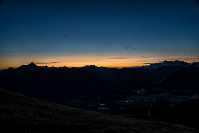 Scenic view of silhouette mountains against sky at sunset