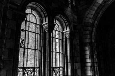 Low angle view of old building seen through window