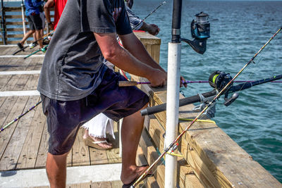 Low section of man working at harbor