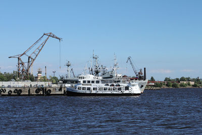 Ships at harbor against sky