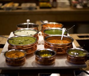 Close-up of food served on table - freshly prepared assorted indian chutneys in copper bowls