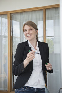 Mid adult woman smiling during presentation, stockholm, sweden