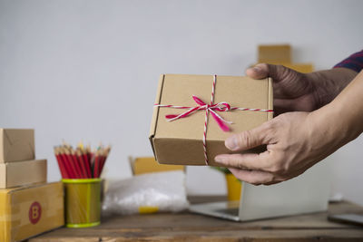 Midsection of person holding paper in box