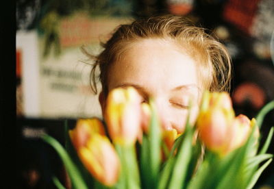 Close-up of smiling woman with tulips