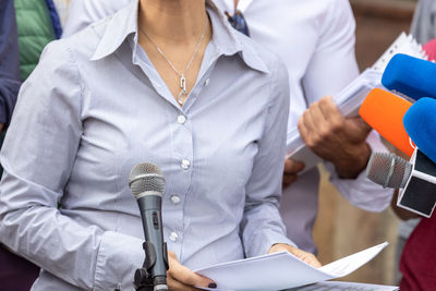 Low section of man and woman standing on paper