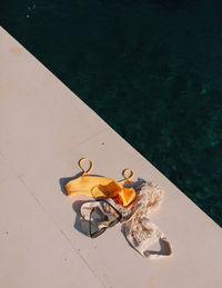 High angle view of personal accessories by sea