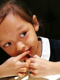 Close-up of cute baby girl in front of flower