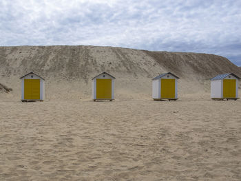 Beach hut against sky