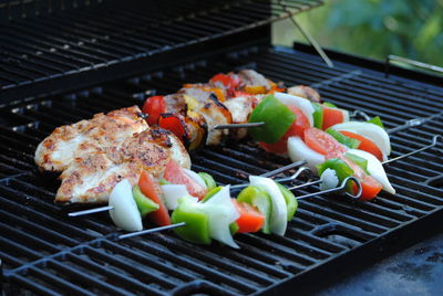 Close-up of food in skewers on barbecue grill