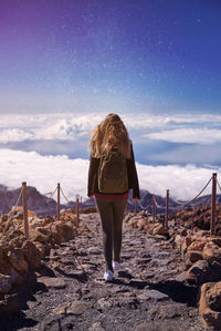 Rear view of woman walking at teide