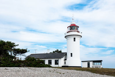 Lighthouse against cloudy sky