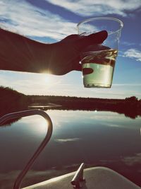 Close-up of hand holding glass of water