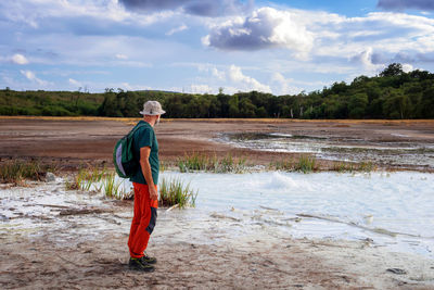 Rear view of woman walking on field