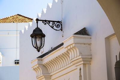 Low angle view of street light against building