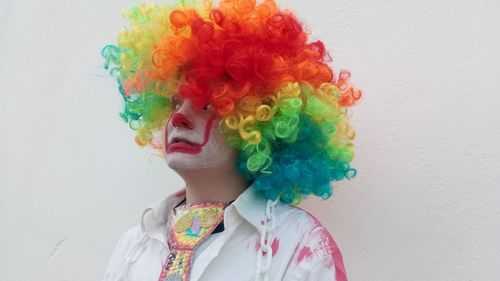 Close-up of boy wearing costume standing against wall