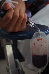 Cropped image of doctor and patient at blood bank