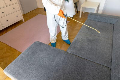 Low section of man standing on floor at home