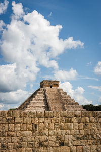 Low angle view of old ruin building against cloudy sky