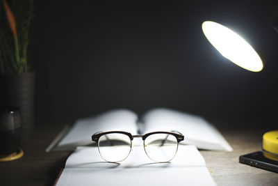 Close-up of illuminated lamp on table