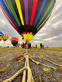 Multi colored hot air balloon flying against sky