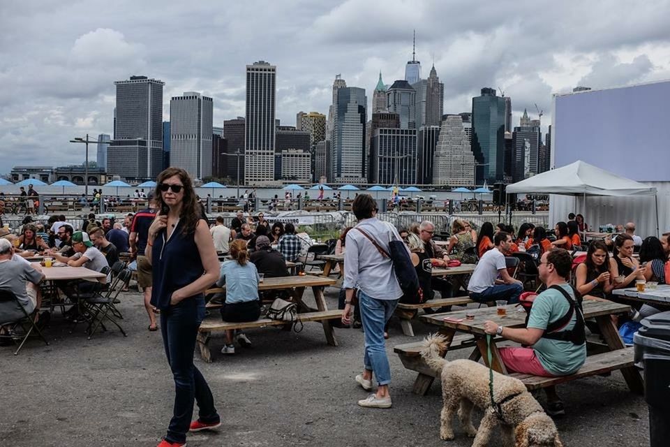 building exterior, architecture, large group of people, lifestyles, city, built structure, leisure activity, person, men, sky, city life, casual clothing, sitting, cloud - sky, cityscape, togetherness, full length, relaxation, mixed age range