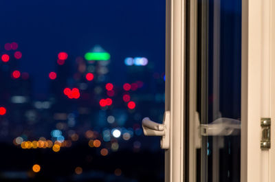 An open window against the blurred view of the skyscrapers of canary wharf, london