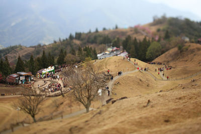 Aerial view of people on mountain against sky