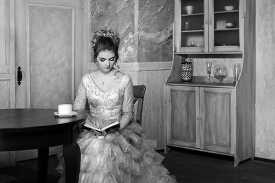 Woman sitting on table at home