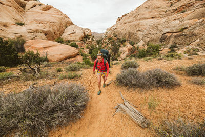 Woman walking by plants on mountain