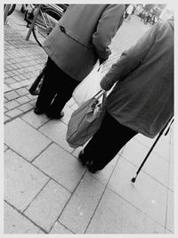 Low section of woman standing on tiled floor