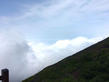 Scenic view of mountains against cloudy sky