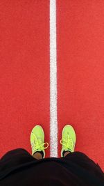 Low section of man standing on sports track