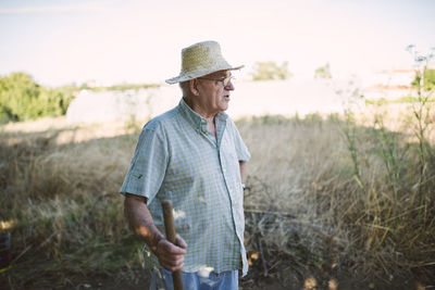 Portrait of a farmer with hatchet looking at distance