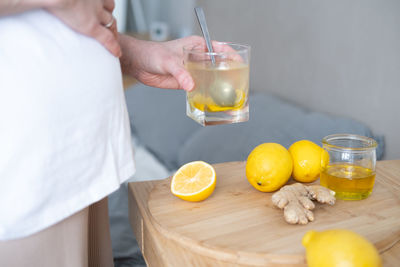 Midsection of man holding fruit on table
