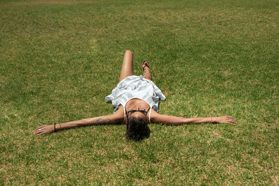 High angle view of woman lying on grass