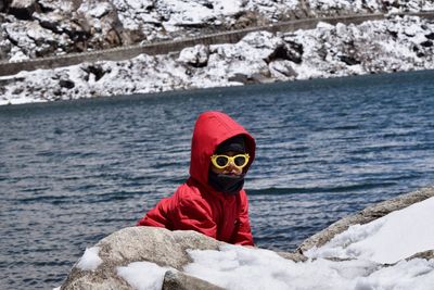 Boy playing on rocks by sea