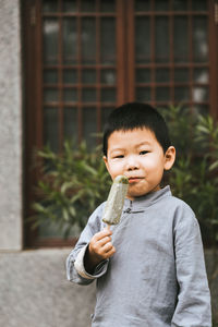 Portrait of cute boy standing outdoors