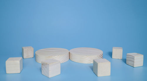 Close-up of white table against blue background