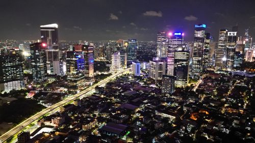 High angle view of illuminated buildings in city at night