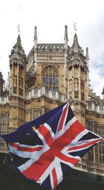 Low angle view of flags against buildings