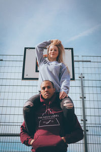 Portrait of happy smiling woman against sky
