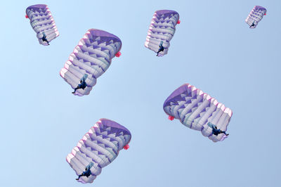 Low angle view of colorful balloons against sky