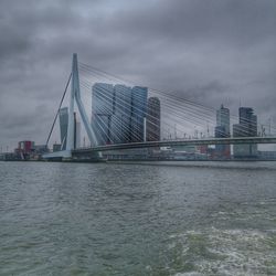 View of bridge over river against cloudy sky