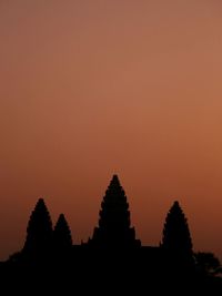 Silhouette temple against sky during sunset