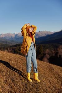 Full length of woman standing on mountain