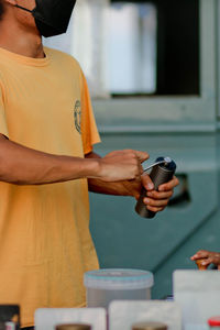 Rear view of man standing on mobile phone