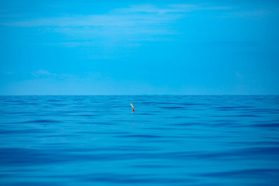 Scenic view of sea against blue sky