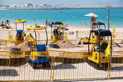 Deck chairs at beach against sky