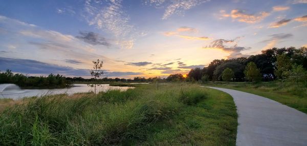 Scenic view of road against sky during sunset